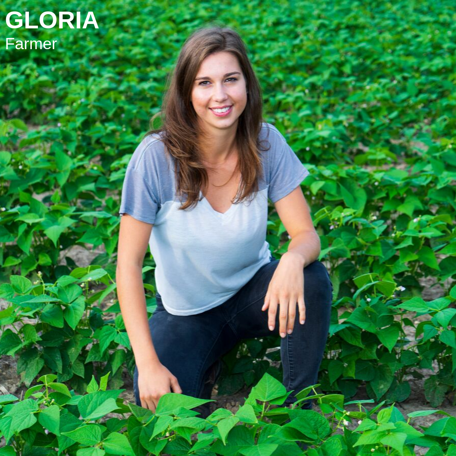 Brunette woman kneeling in bean field
