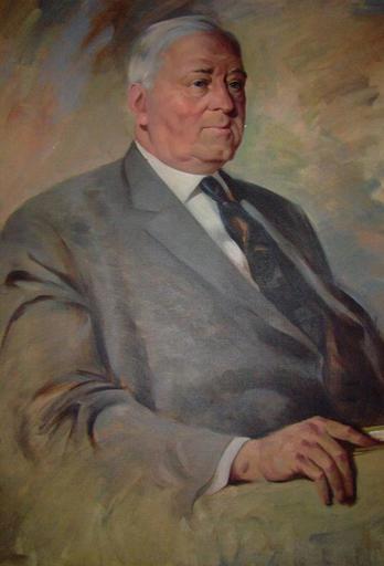 Portrait of Dr. Tye, and older gentleman with gray hair wearing a suite and tie