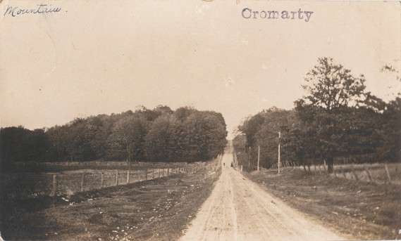 A black and white photograph of a gravel road in the countryside of Cromarty, Ontario.
