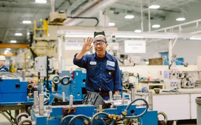 Person working in manufacturing waving