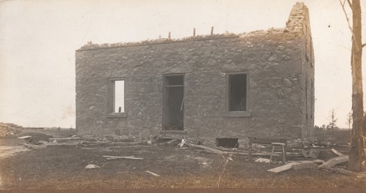 Damaged building with its roof torn off from the tornado in Monkton in 1916.